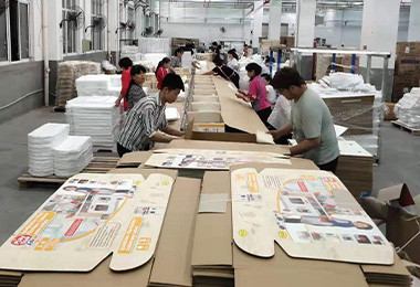 Forestoy production team assembling printed retail display packaging for wooden toy sets