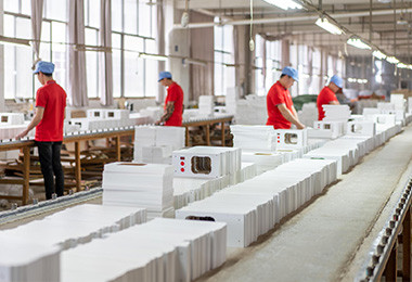 Packed wooden toy retail boxes moving along the Forestoy packing line