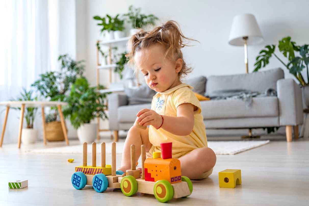 Child playing with a wooden stacking toy