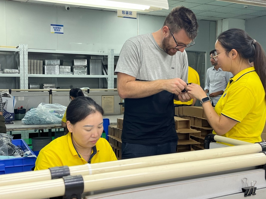 Visitors observe component inspection and handling activities in a SiliconePlus production area