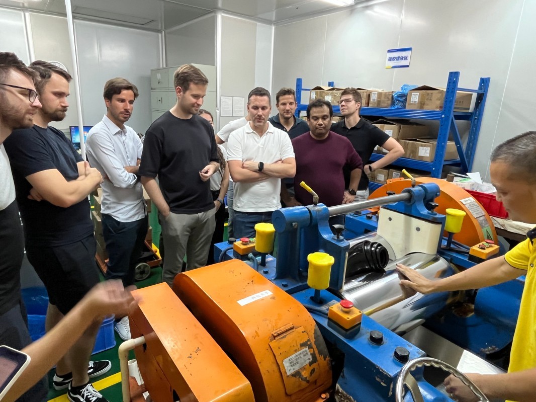 International customers observe silicone rubber mixing equipment during the SiliconePlus factory tour