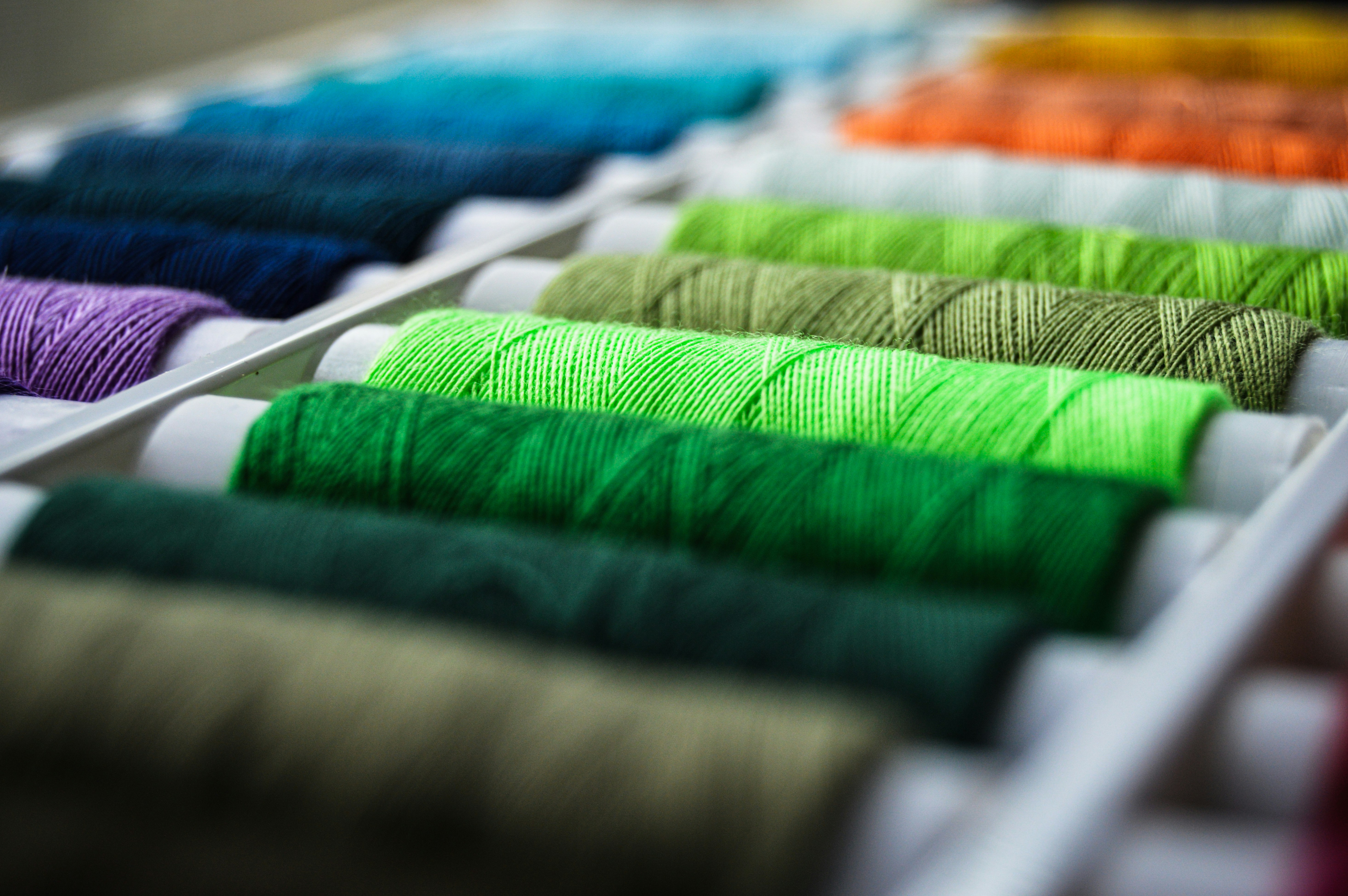 A collection of eco-friendly fabric swatches including recycled polyester, organic cotton, and bamboo.