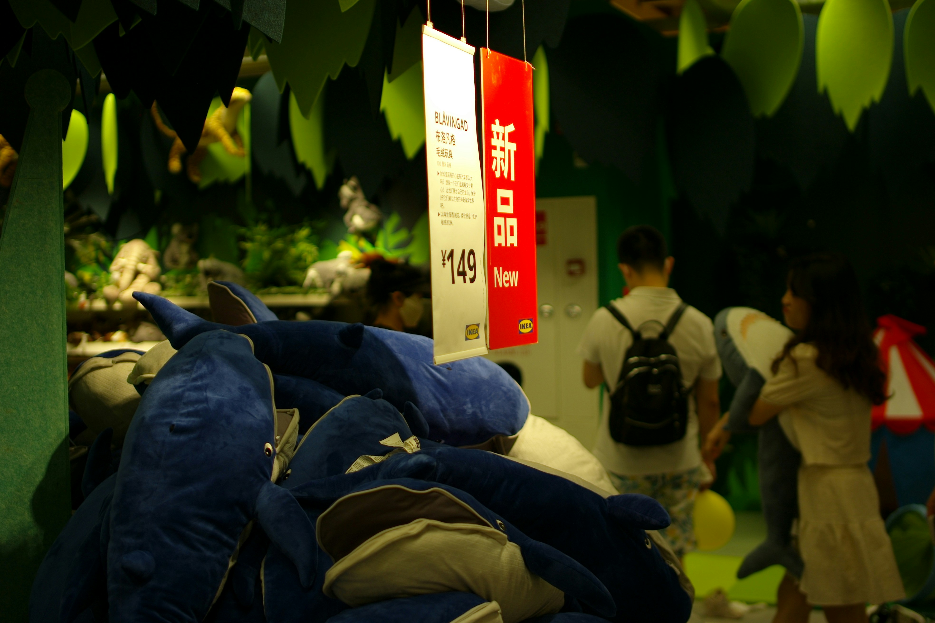 A display of eco-friendly sportswear fabrics like recycled polyester and bamboo, with GRS and bluesign certification tags.