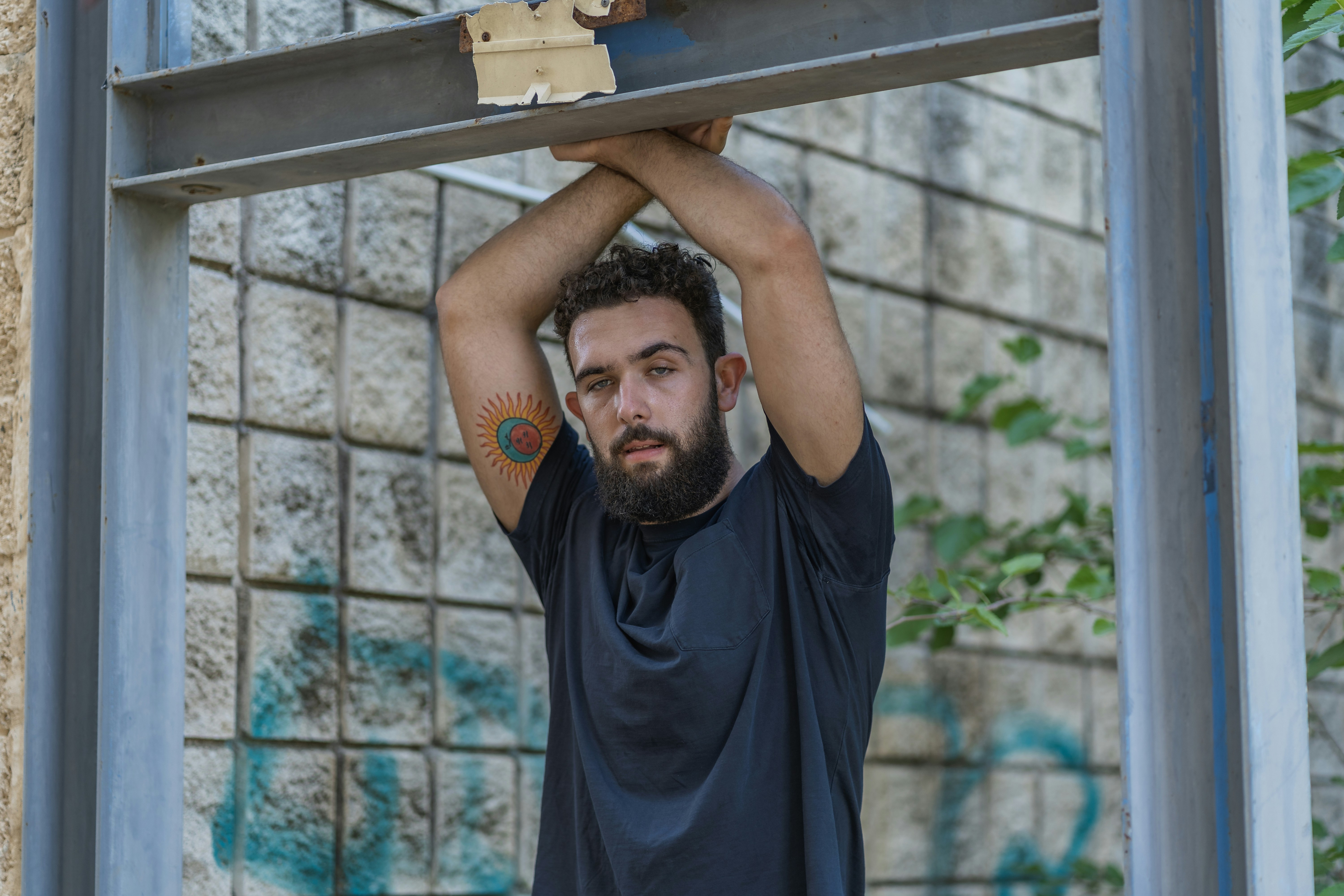 A person confidently wearing a modest gym top in an urban setting