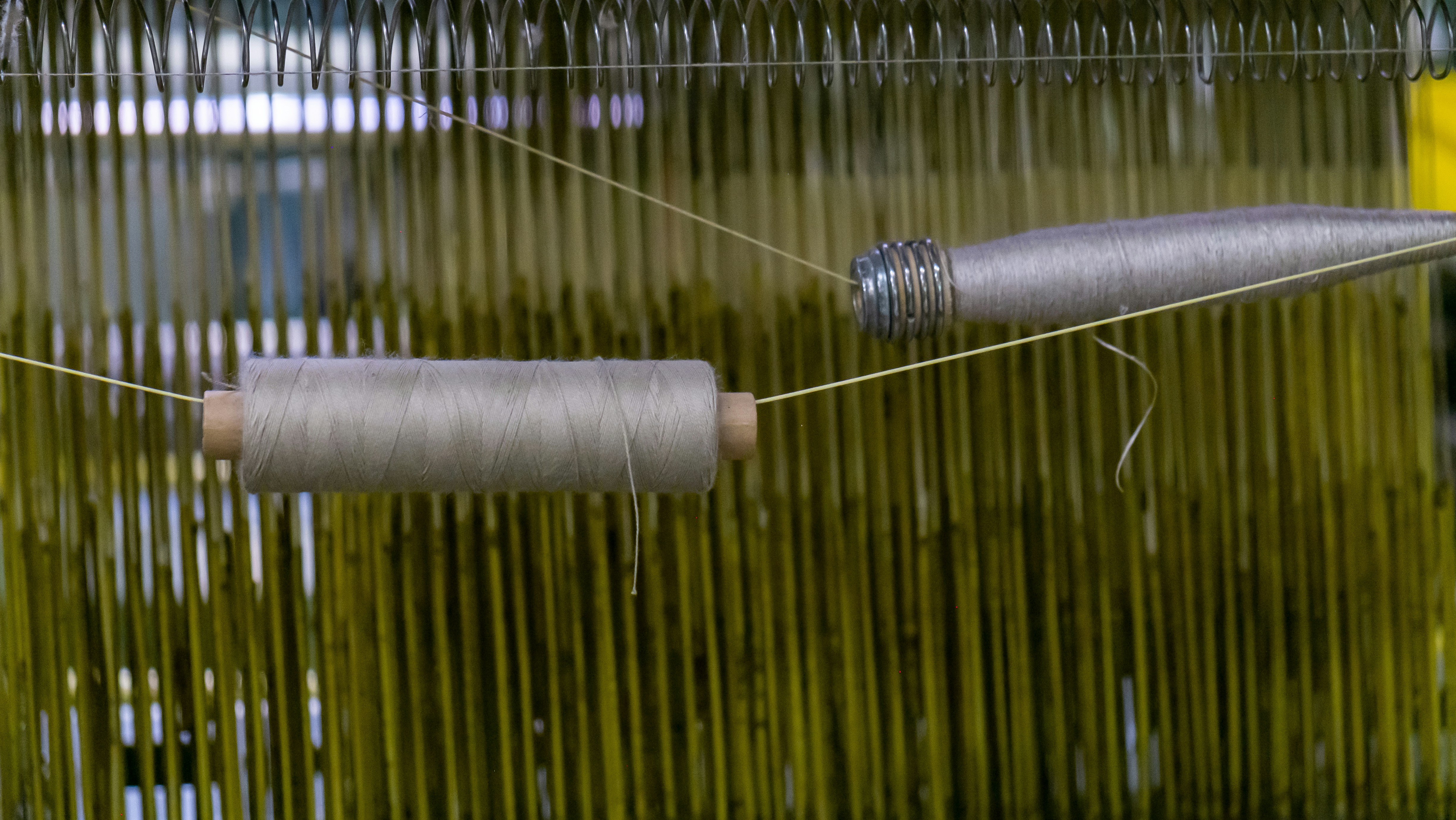 State-of-the-art manufacturing equipment, including seamless knitting and four-needle six-thread stitching machines.