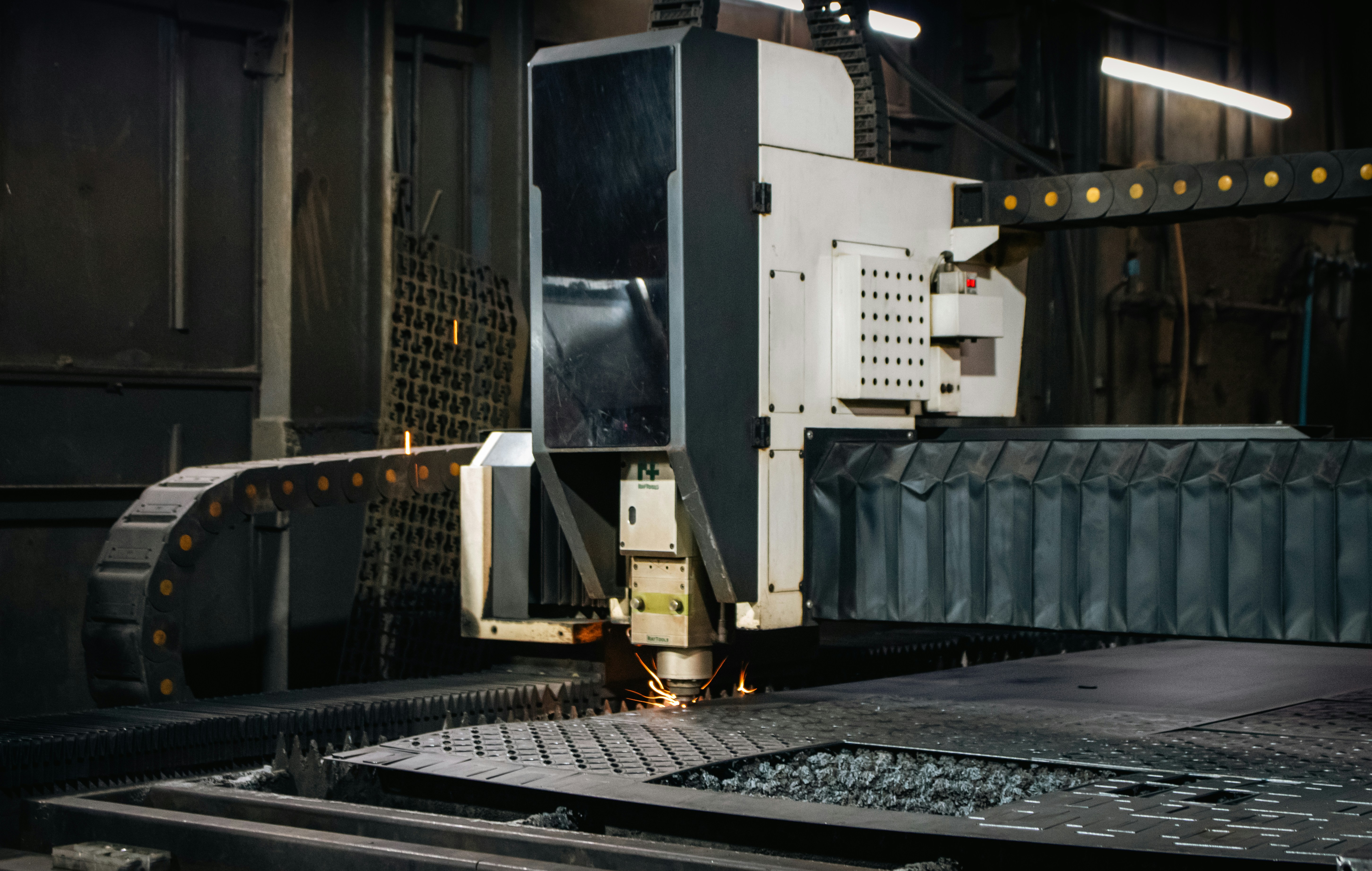 Automated fabric cutting machine precisely cutting layers of textile in a modern factory.