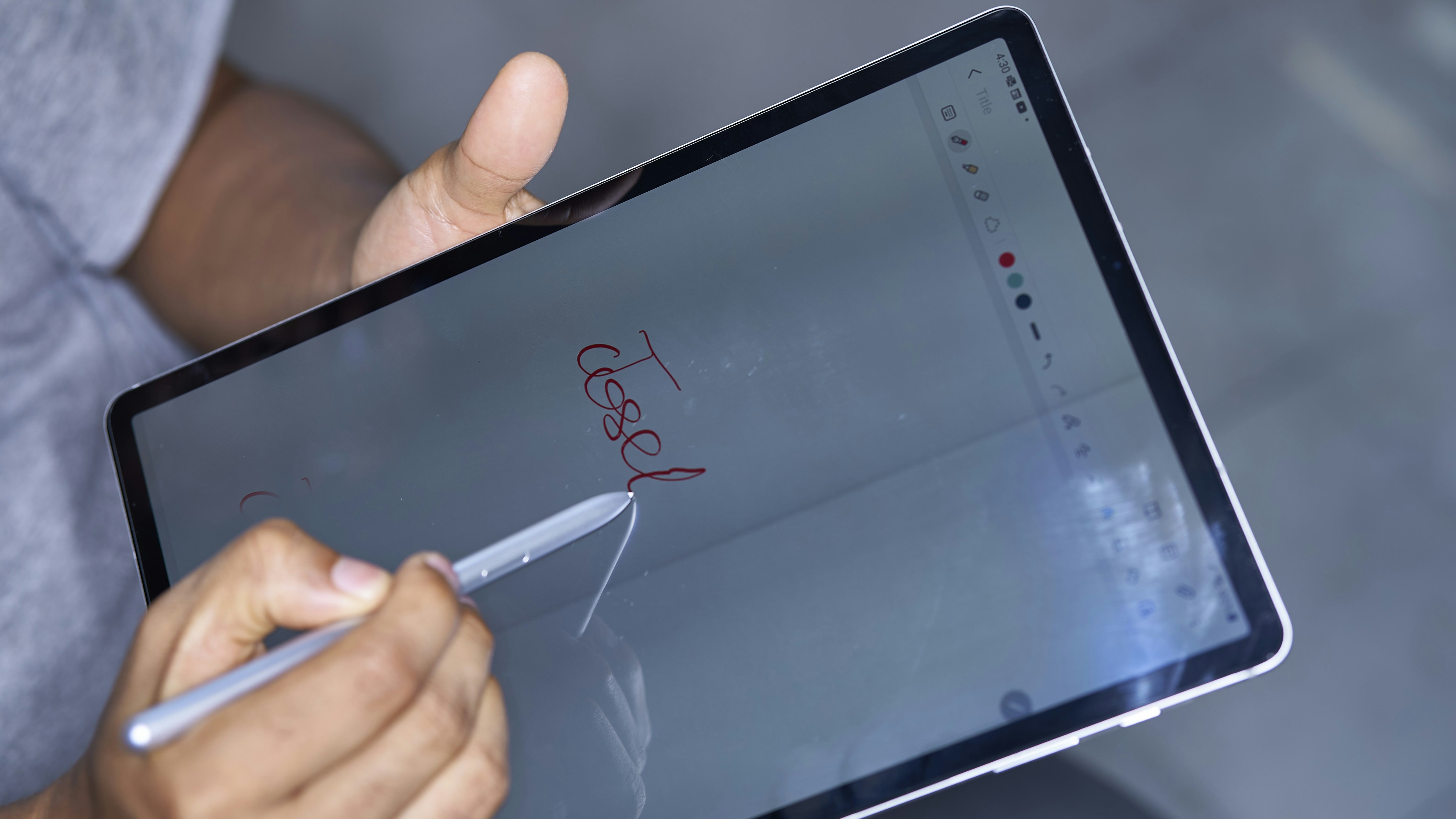 A person sketching a yoga bra design on a tablet