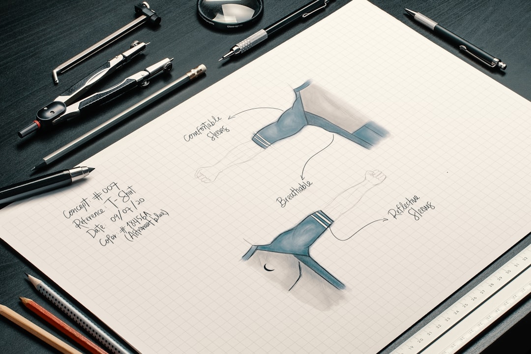A designer sketching activewear designs in a notebook