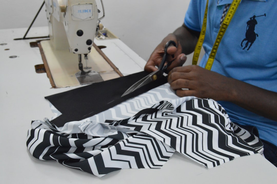An inspector checking the stitch quality on a pair of leggings