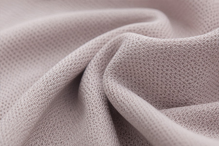 A close-up view of a moisture-wicking fabric showing its unique texture and weave, ideal for custom activewear samples.