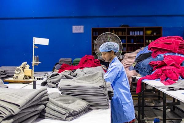 Factory workers performing quality checks on activewear garments
