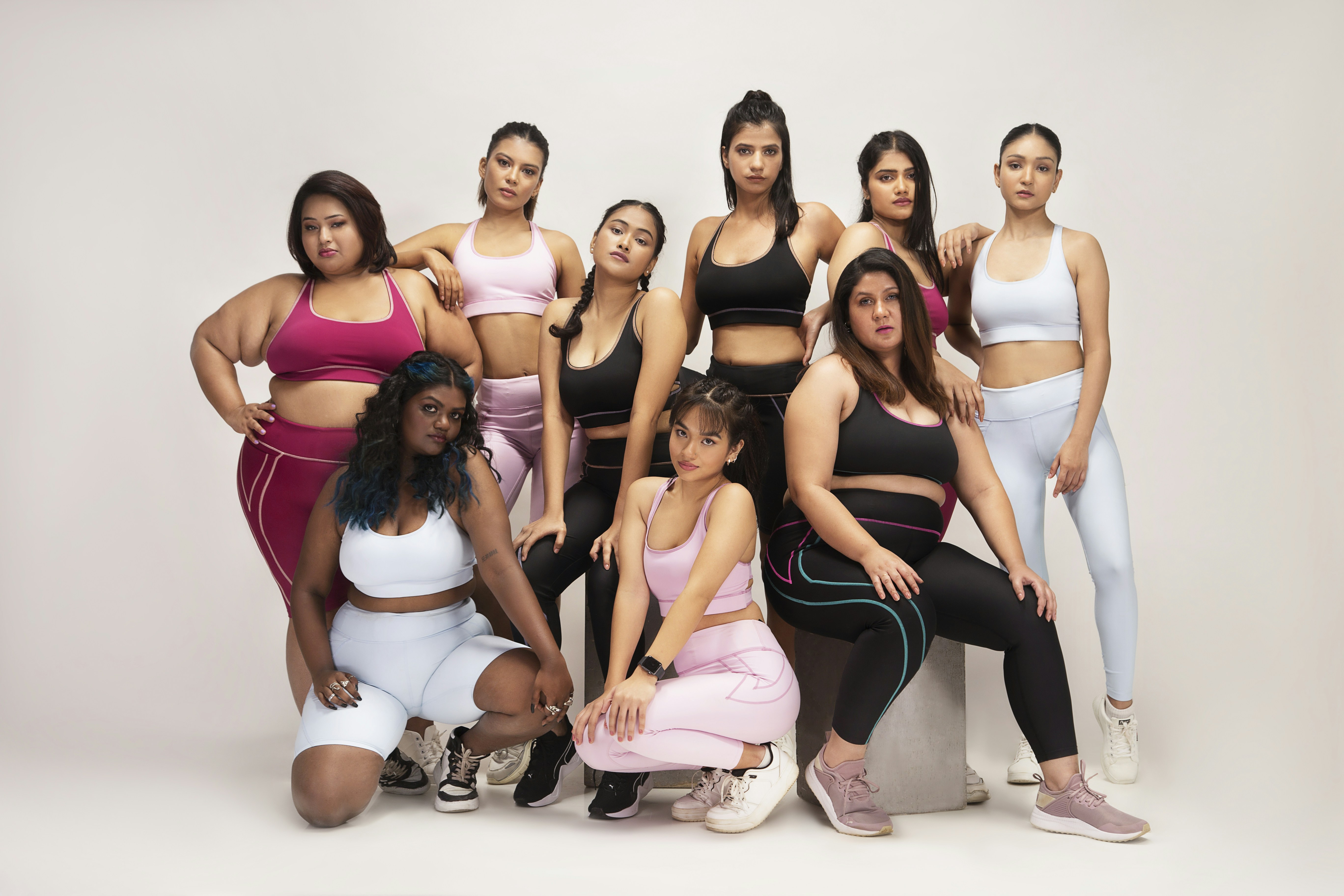 A diverse group of models of different body shapes and sizes wearing well-fitting activewear