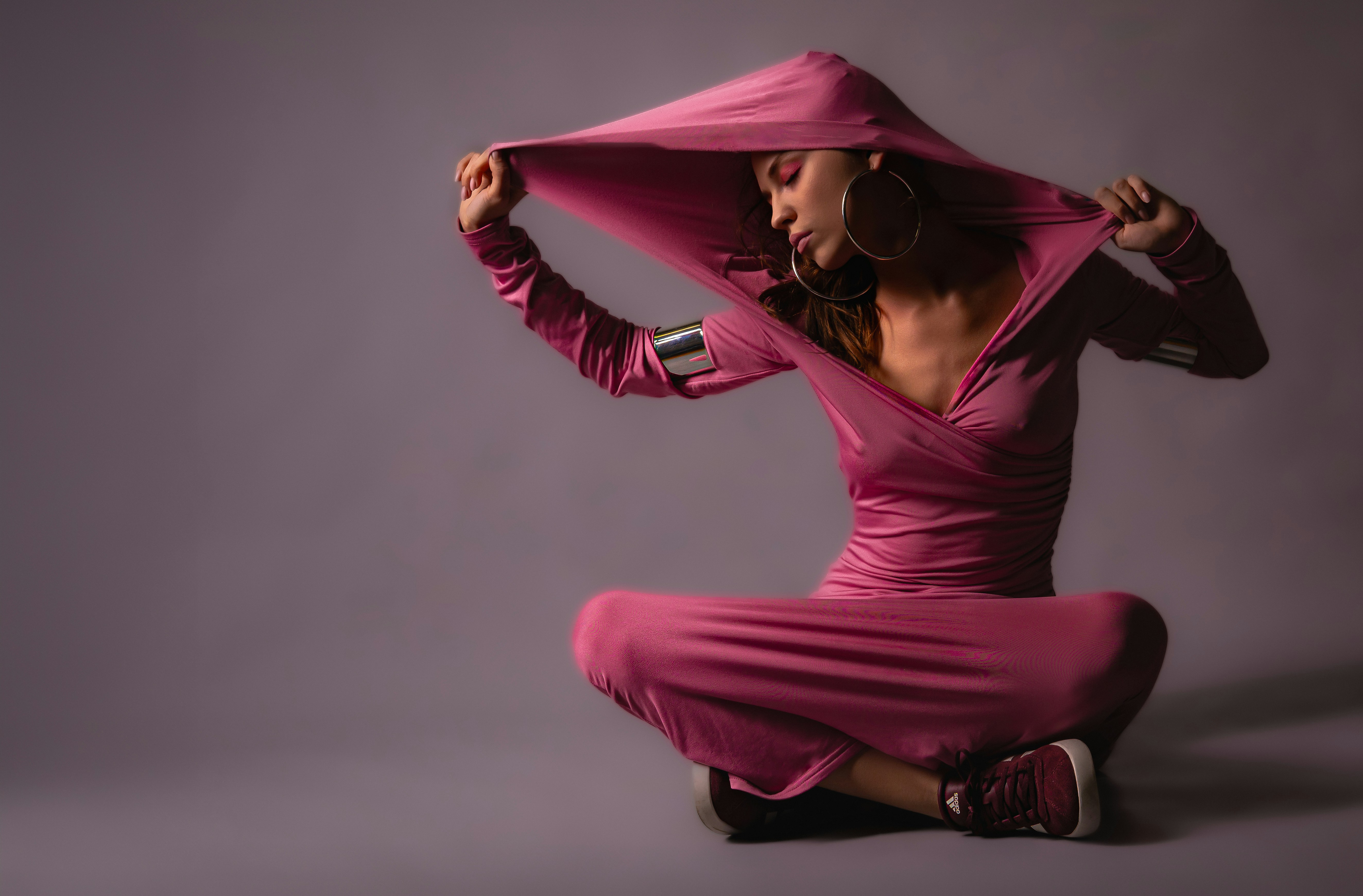 A full-body shot of a model wearing activewear that showcases the fabric's elegant drape and how it flows with movement