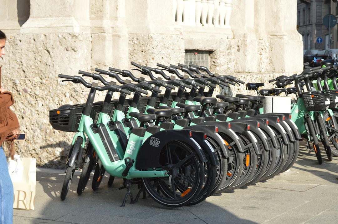 A collection of 2025-2026 electric dirt bikes on a starting line