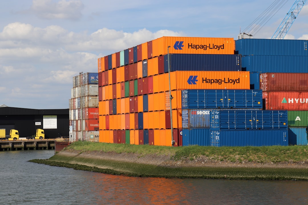 A large container ship at a port, representing international freight and logistics