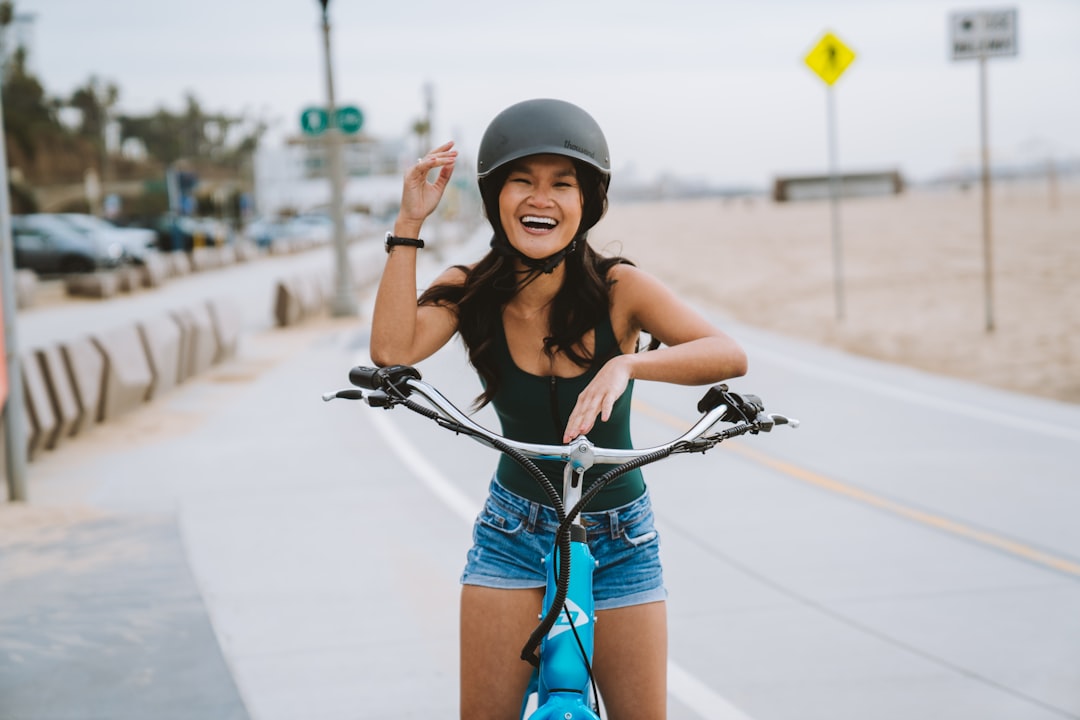A customer smiling while test-riding an electric bike outdoors