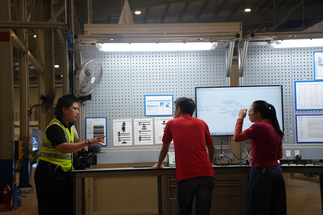 An inspector reviewing an electric bike on a factory assembly line.