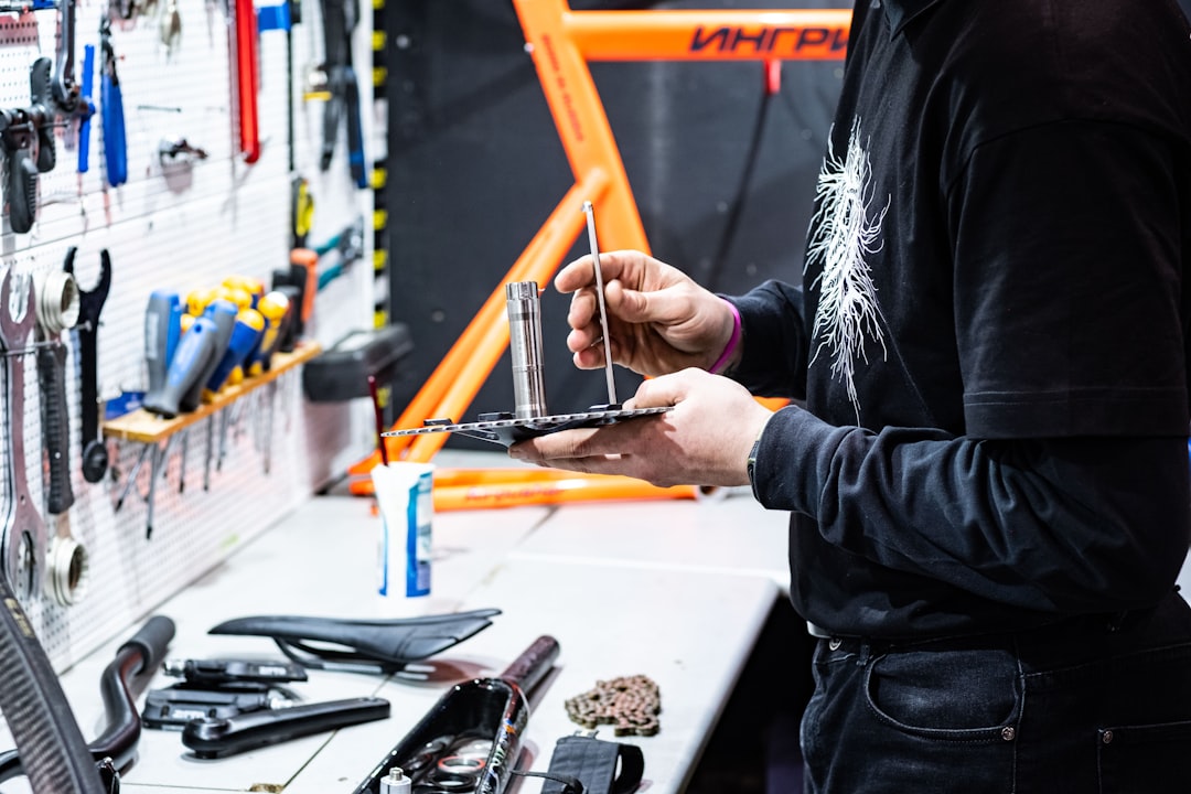 A person using an Allen key to assemble the handlebars of a new e-bike