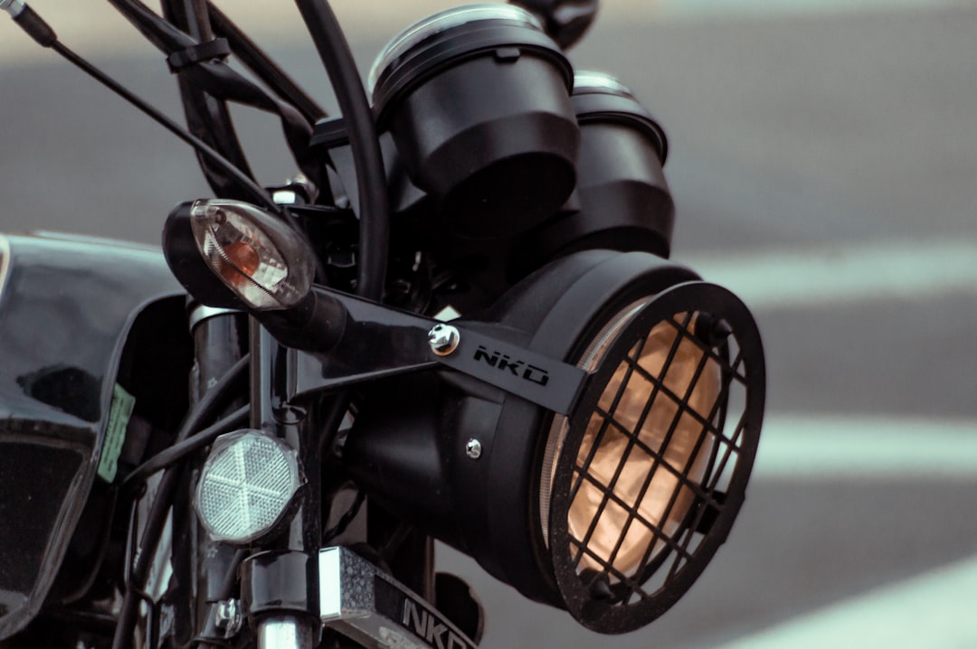A close-up of a street-legal electric dirt bike's headlight and turn signal.