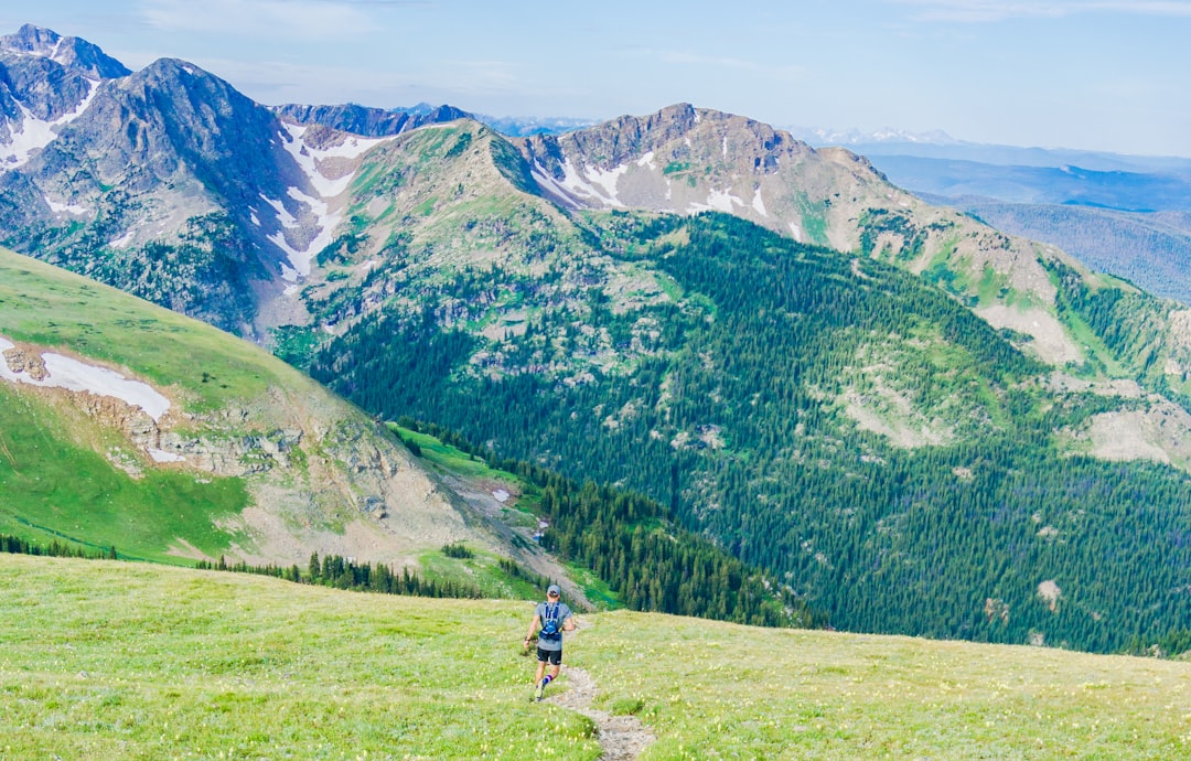 Electric dirt bike on a rocky trail with mountains in the background