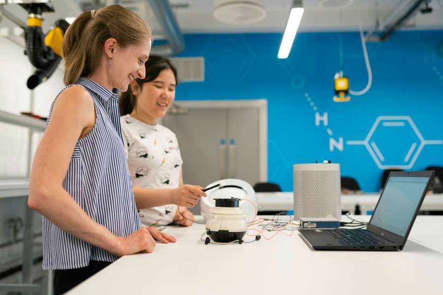 Engineers working with analytical equipment for DFM verification