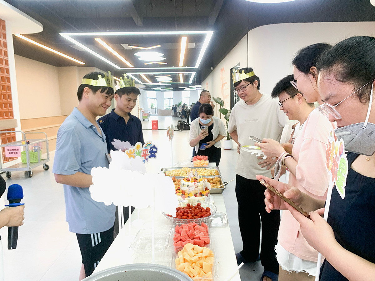 Company staff group photo at monthly employee birthday party, warm corporate team building & enterprise culture scene with birthday cake, fruits and snacks