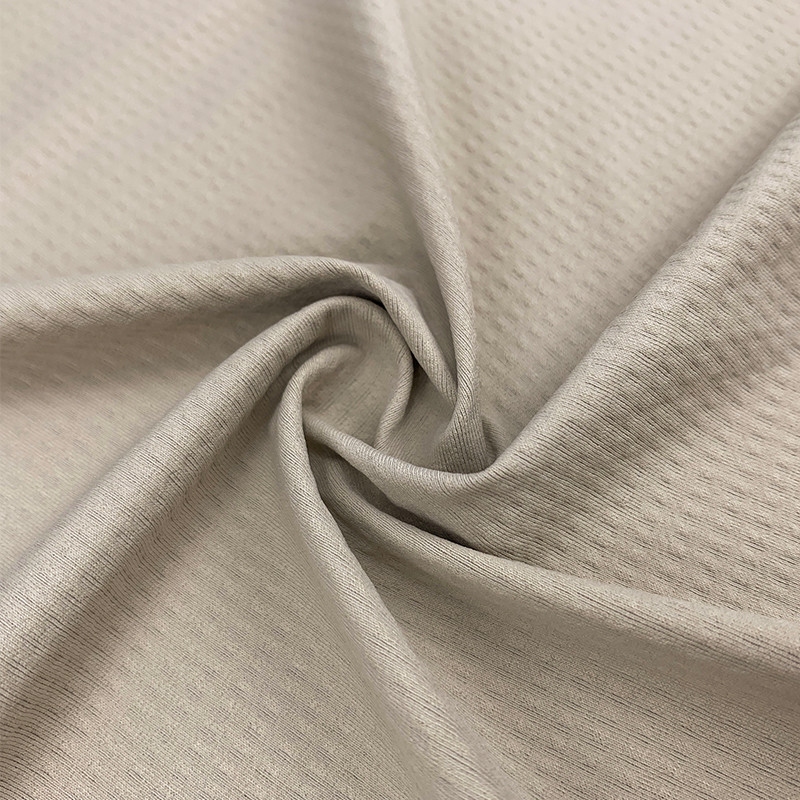 Light beige mesh hole quick-dry knit fabric texture, AIR-ICY moisture wicking breathable sportswear fabric close-up from Faybric