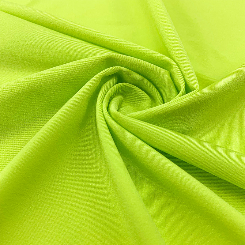 Twisted close-up of bright neon lime green stretch knit fabric, Faybric AIR-ICY soft elastic functional sportswear textile