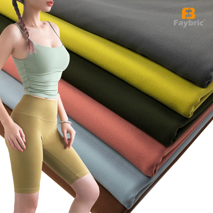 Double sided brushed spandex knit fabric multi color swatches with yoga activewear model display