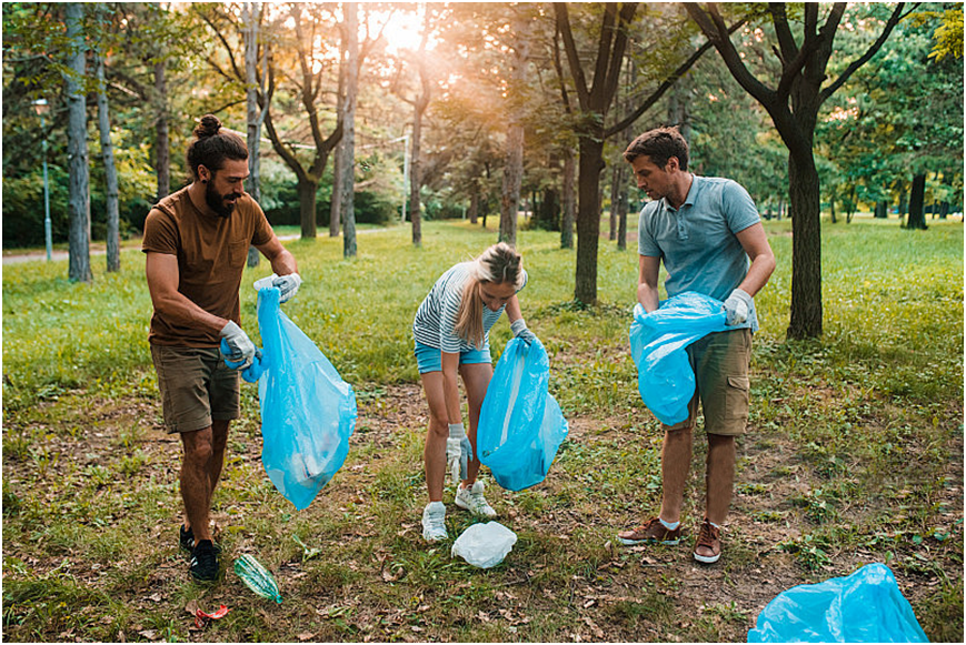 Volunteers collecting waste plastic bottles for recycled polyester sustainable eco sport fabric production