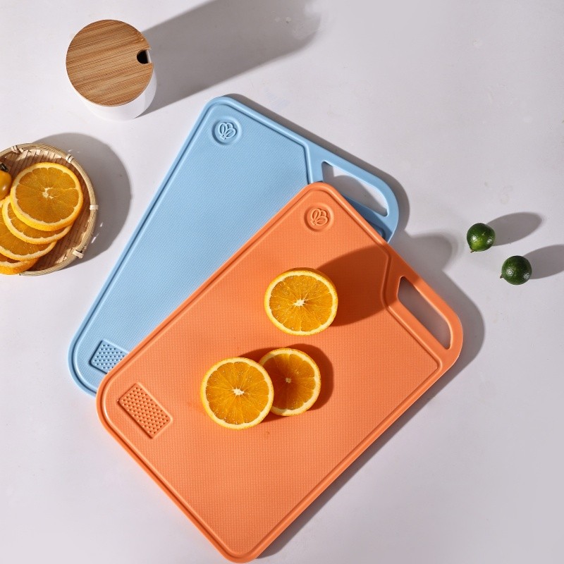 ChopAid reversible cutting boards displayed on a modern kitchen island with fresh vegetables and knives
