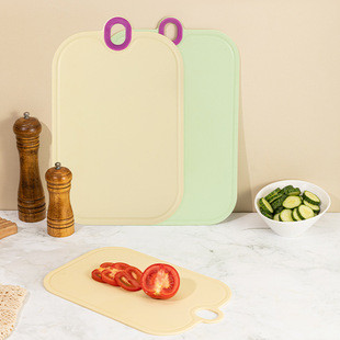 A family cooking together, children safely chopping fruits on colorful TPU magic cutting boards, eco-friendly lifestyle concept