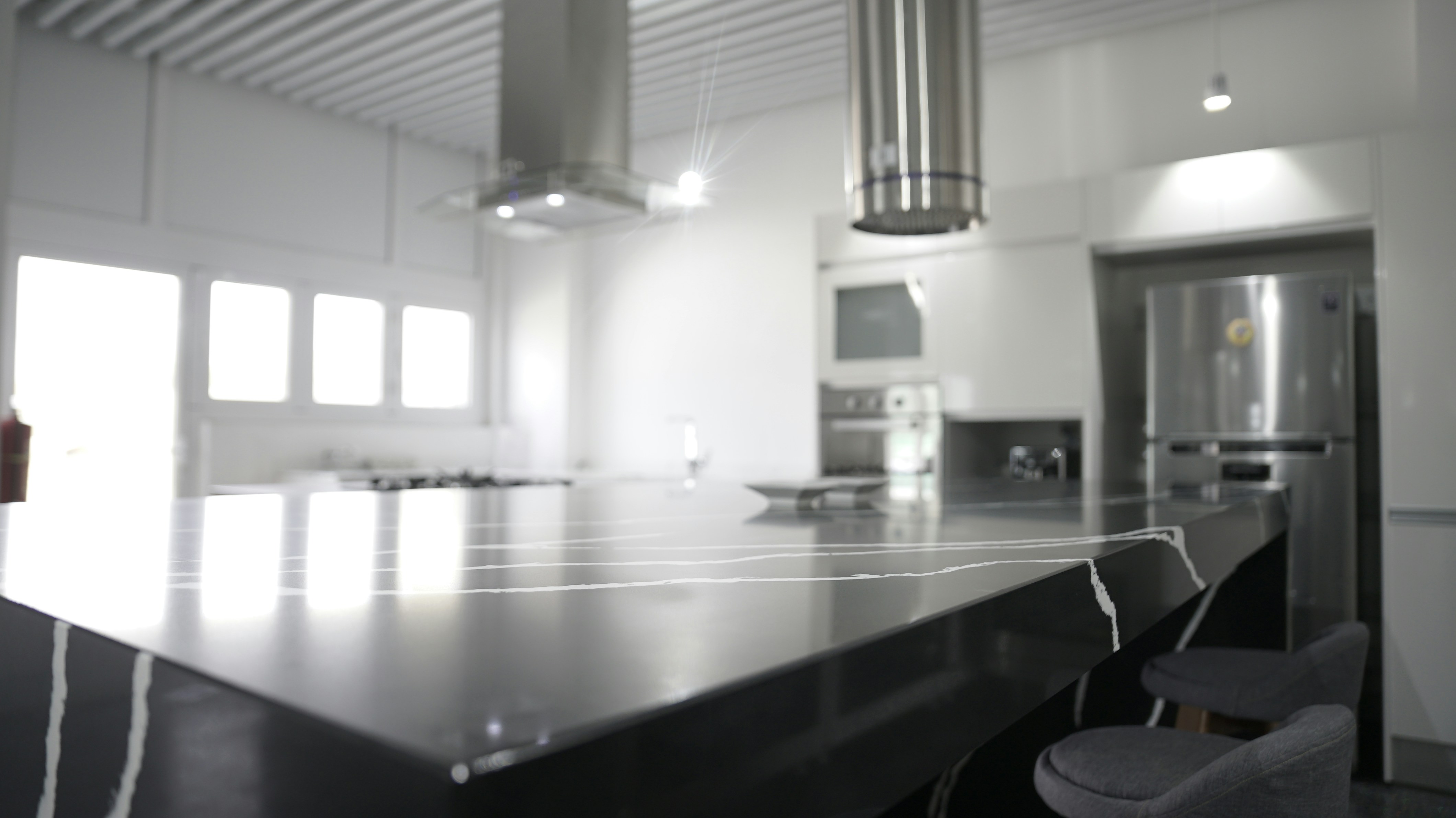 A sleek, brushed stainless steel cutting board on a modern kitchen counter