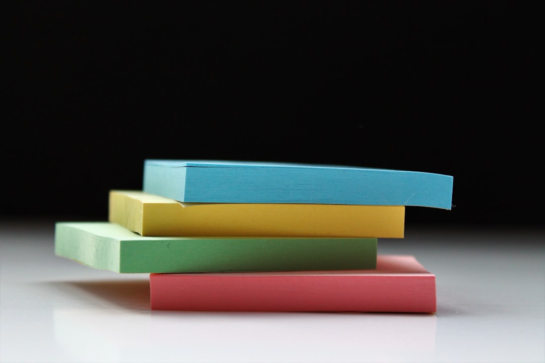 A clean stack of multi-colored plastic chopping boards