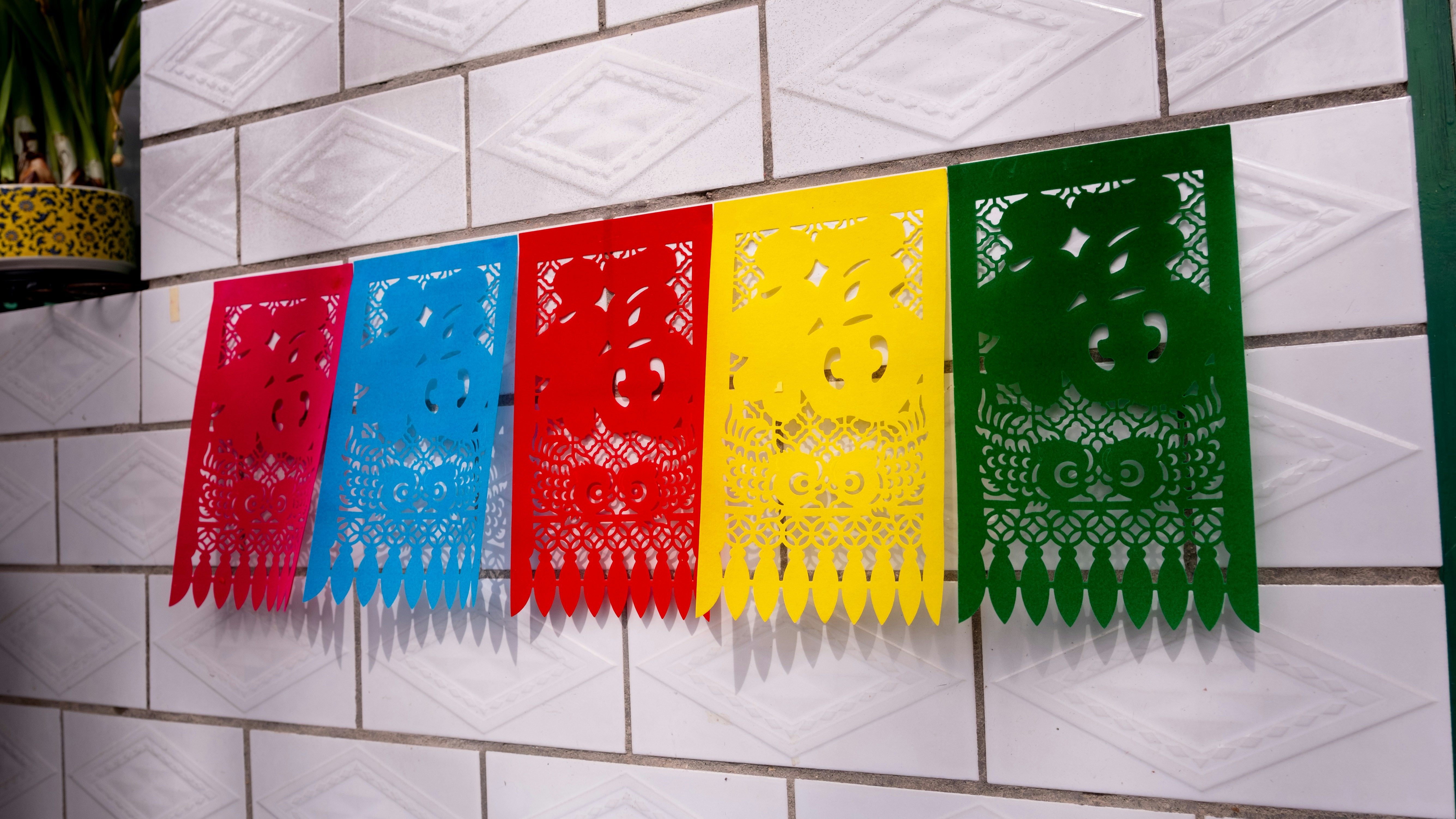 A set of color-coded plastic cutting boards: red, green, blue, and yellow.