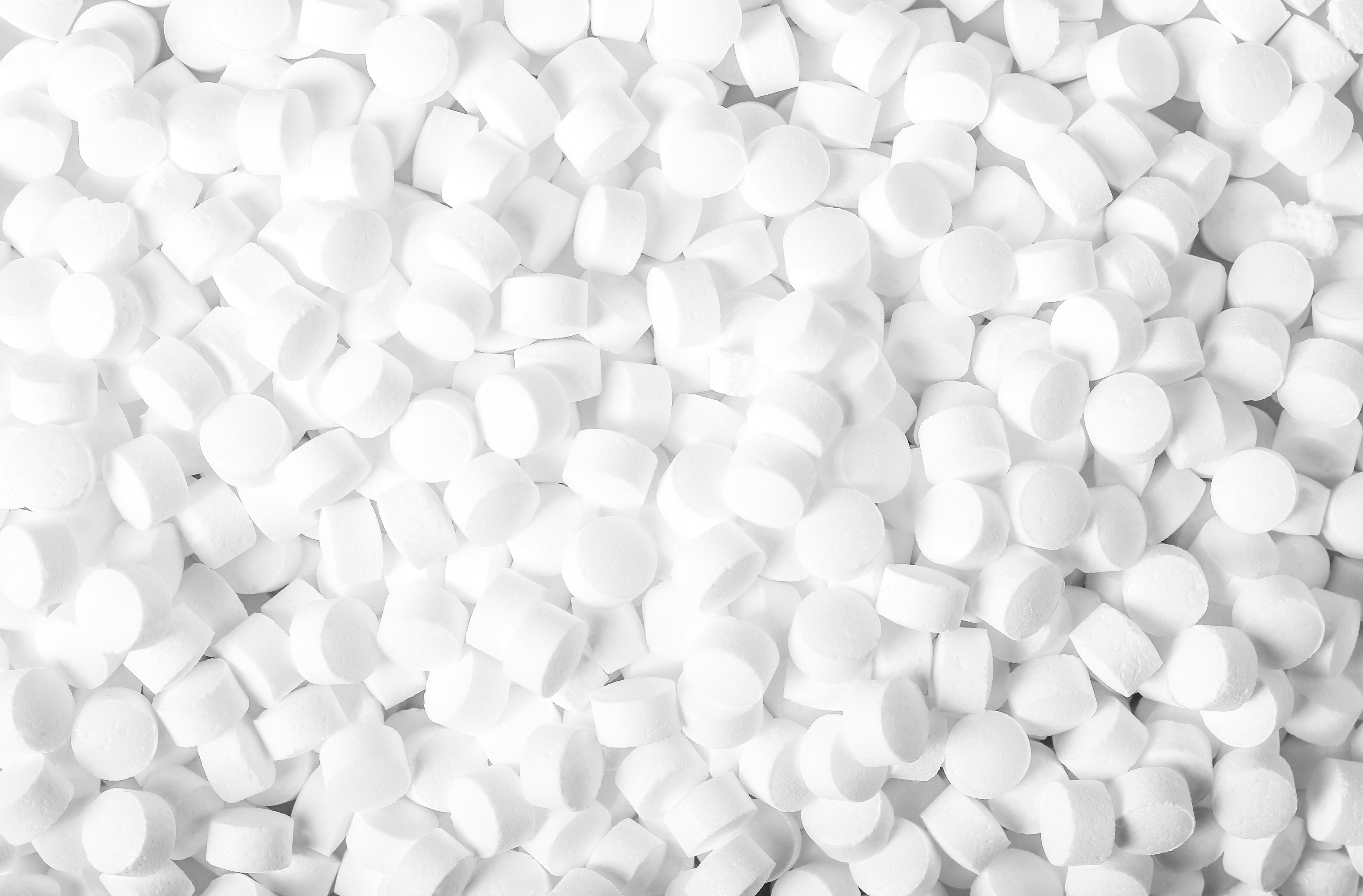 Raw HDPE Plastic Pellets A close-up shot of raw HDPE plastic pellets