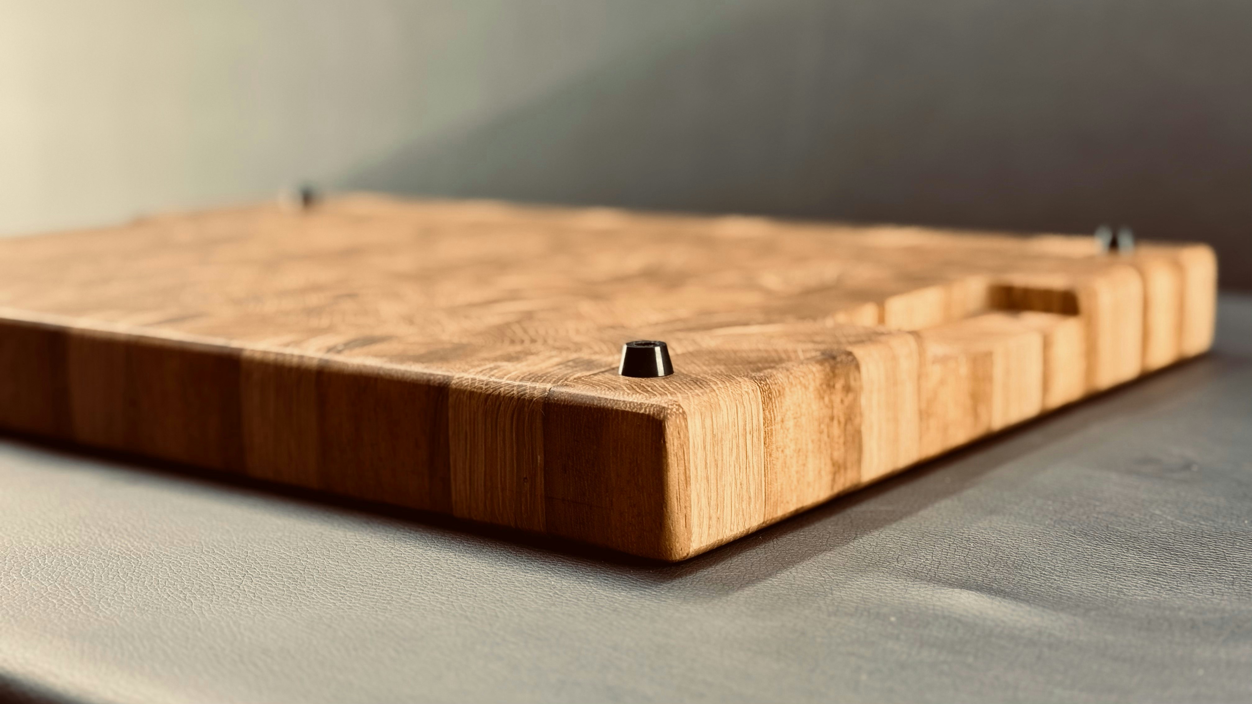 Close-up of an end-grain wooden cutting board showing the self-healing fibers.