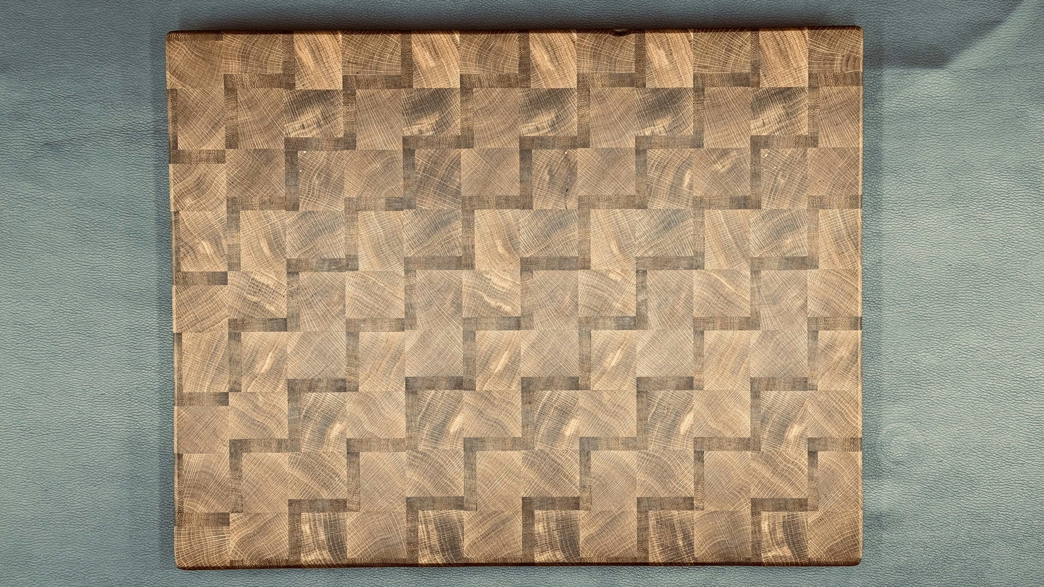 A close-up shot of an end grain wooden cutting board showing the checkerboard pattern