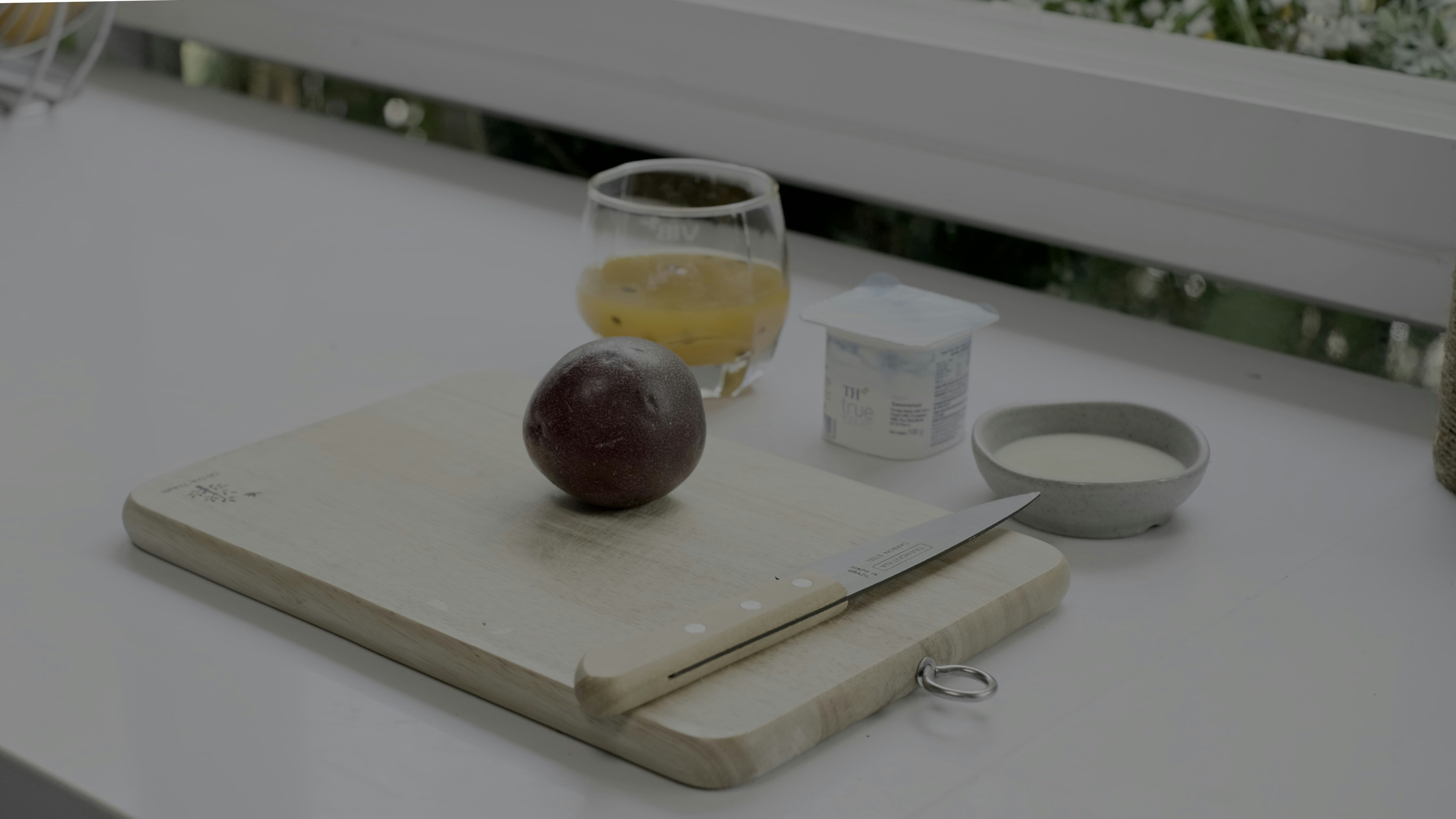 A foldable plastic cutting board sliding neatly into a slim drawer, showcasing its space-saving design.