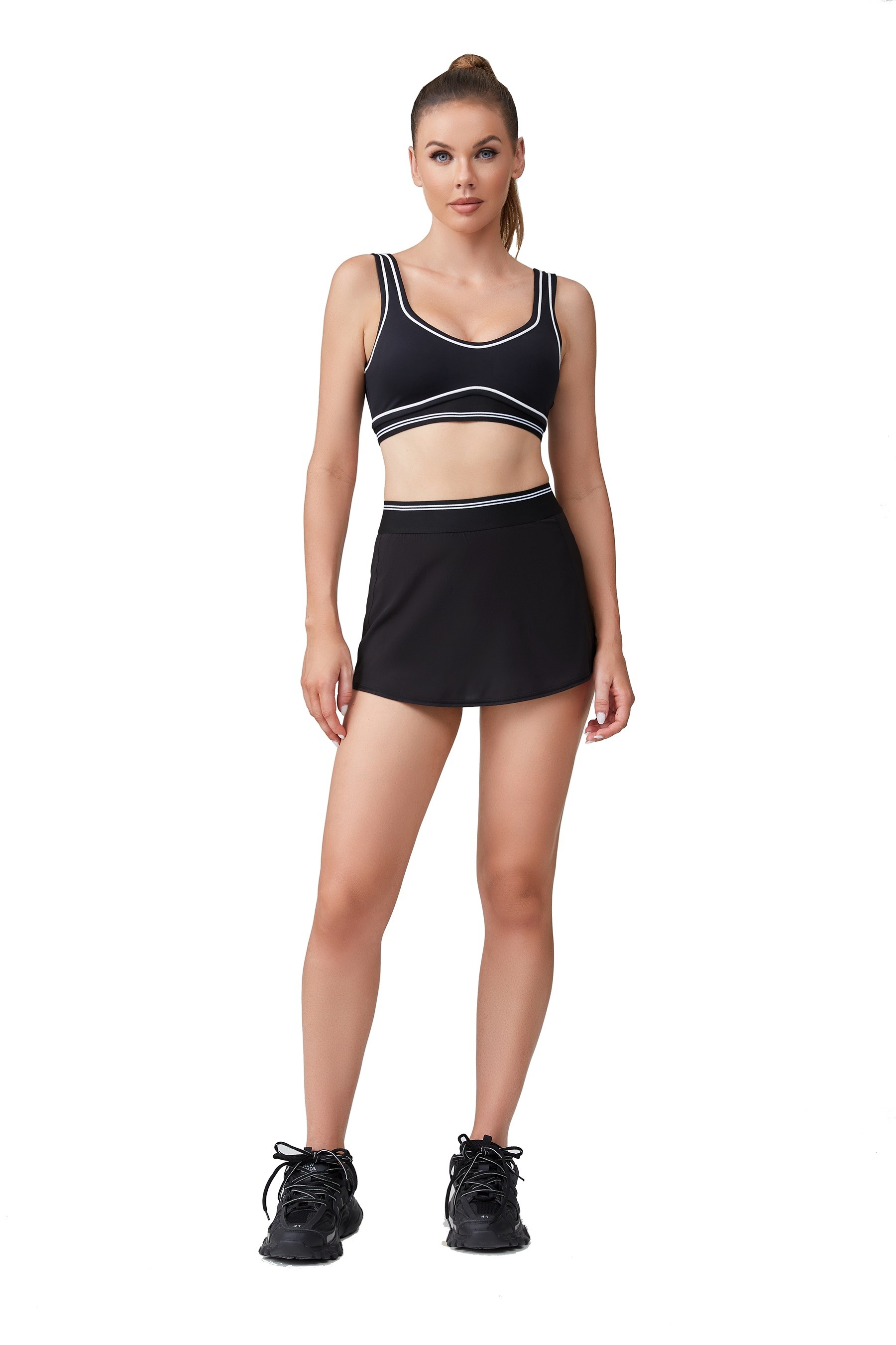 Black and white sculpted sports bra and tennis skirt
