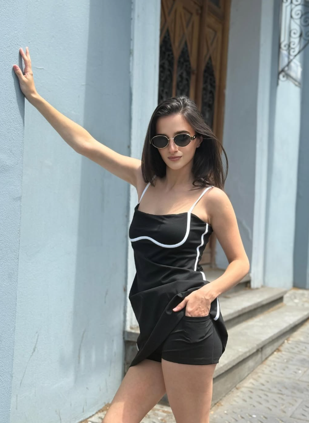 Black minimalist tennis dress with contrast trim and built-in shorts