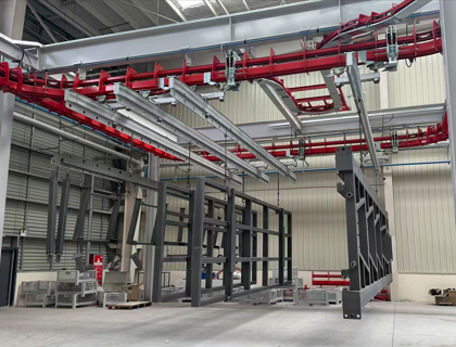 What material is used for the wheels in CamelConvey's enclosed track chain?