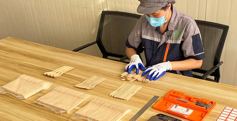 QL production team inspecting finished bamboo cutlery