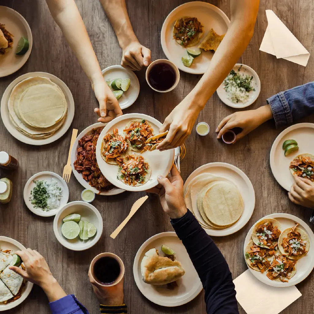 Bamboo plates and cutlery set on a shared dining table