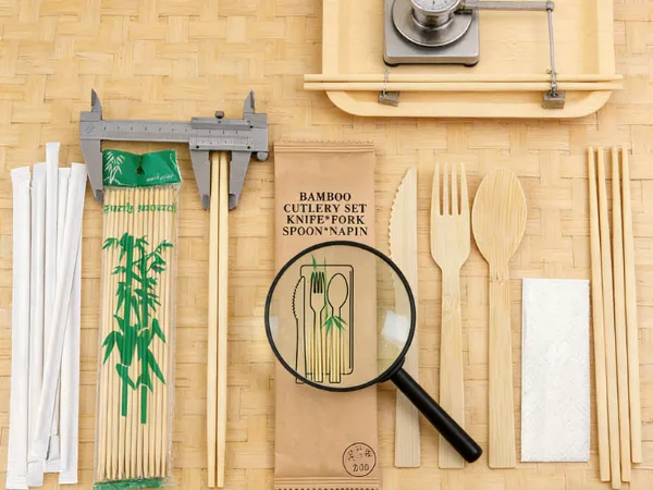 Bamboo cutlery set measured with calipers and inspected under a magnifier