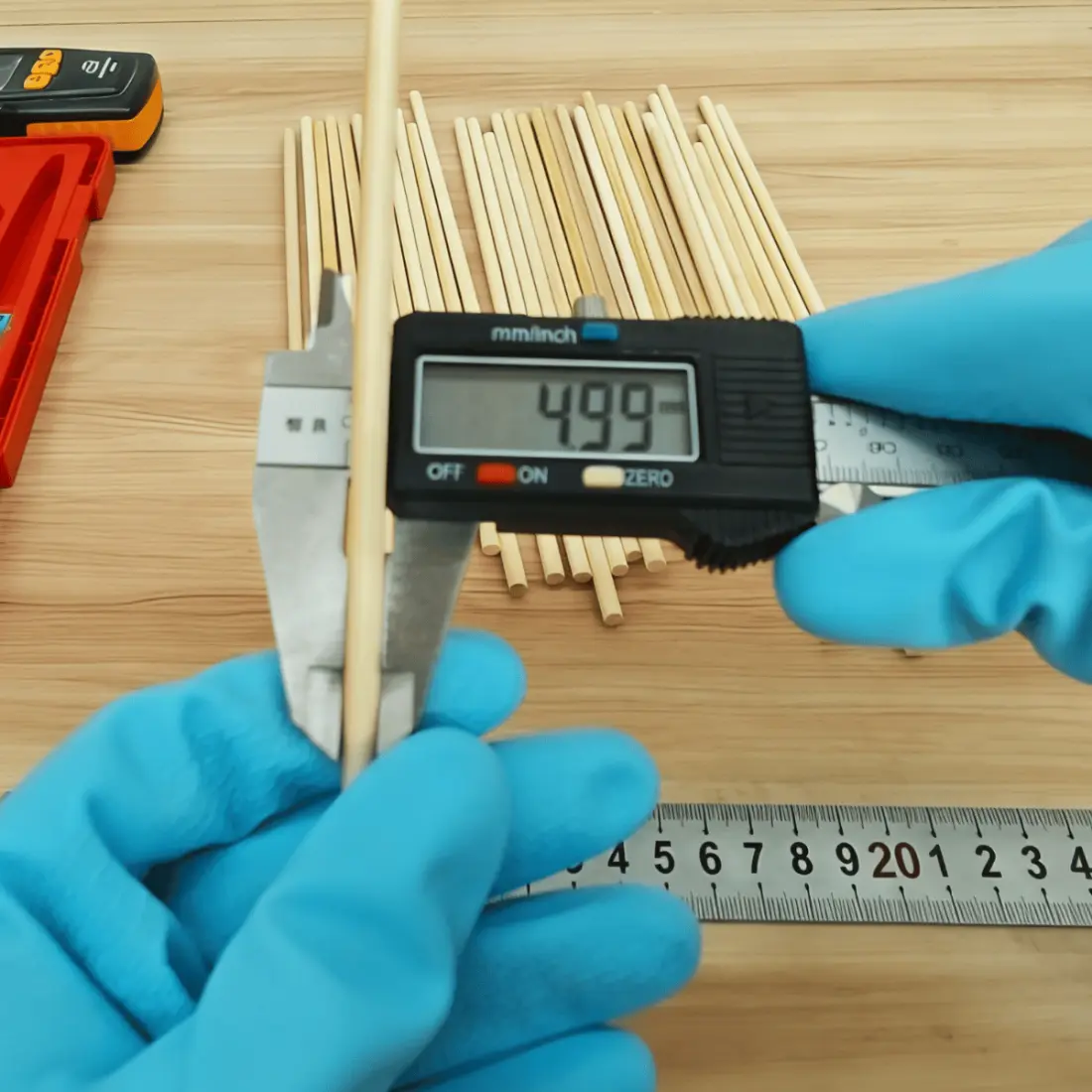 Worker measuring bamboo tableware thickness with a digital caliper