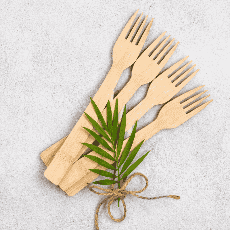 Natural disposable bamboo forks on concrete background