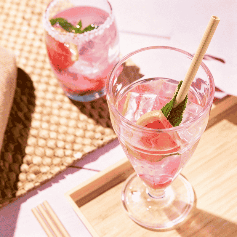 Natural bamboo straw in a refreshing pink iced cocktail
