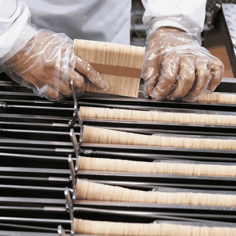 Feeding bamboo sticks into machine