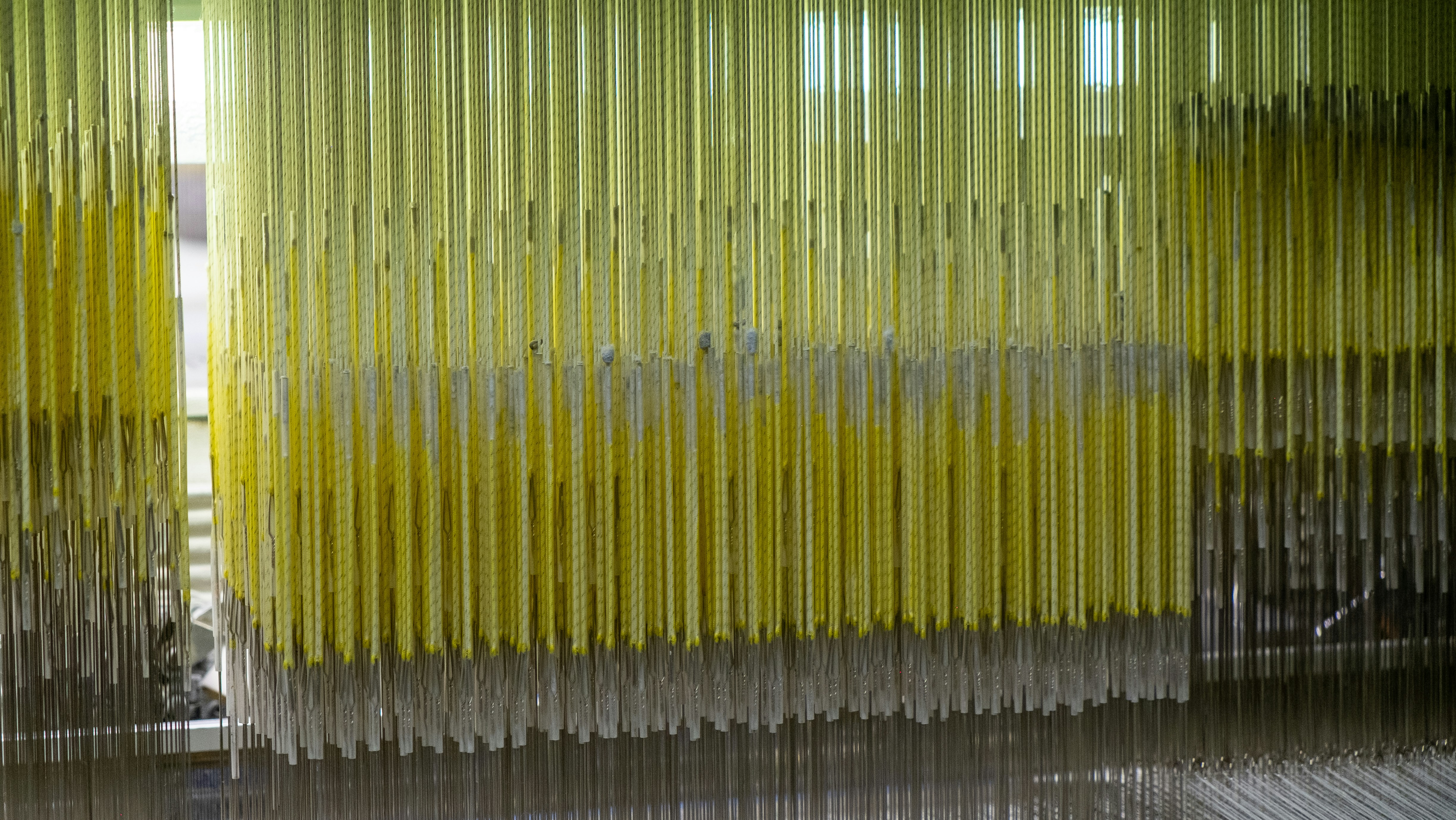 A display showing various eco-friendly synthetic brush filaments made from recycled materials.